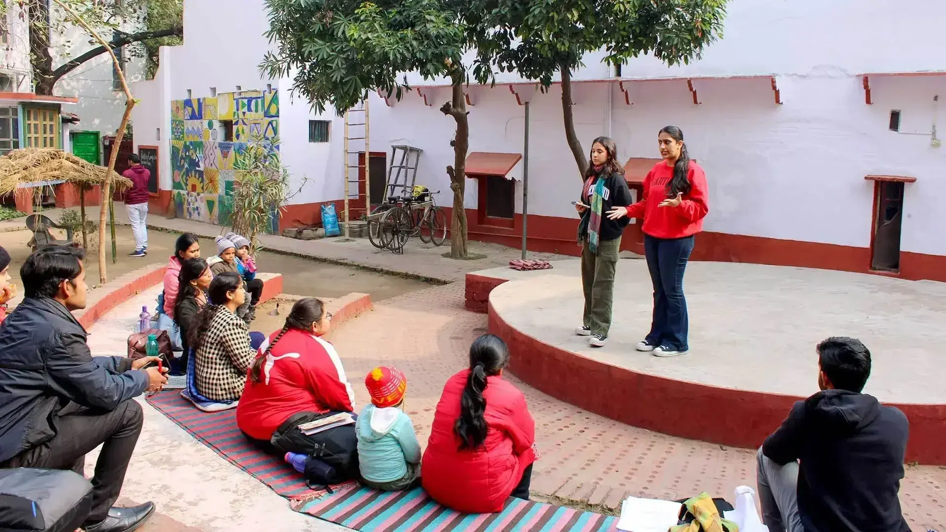 Group of people watching people speaking on a stage